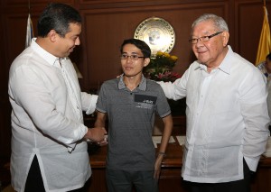 House Speaker Feliciano Belmonte Jr. (right) and House Independent Minority Bloc leader and Leyte (1st Dist) Rep.Ferdinand Martin "FM" Romualdez (left) congratulates Rommel Rhino Edusma (center) from Asian Development Foundation College Tacloban City , for topping the recent Certified Public Accountant Board Examination 2014.Romualdez filled a resolution commending Edusma for his trailblazing achievement of being the topnocher in the recent CPA board exam despite the sufferings he endured after surviving  the world's  most powerful typhoon "Yolanda".photo by Ver Noveno  